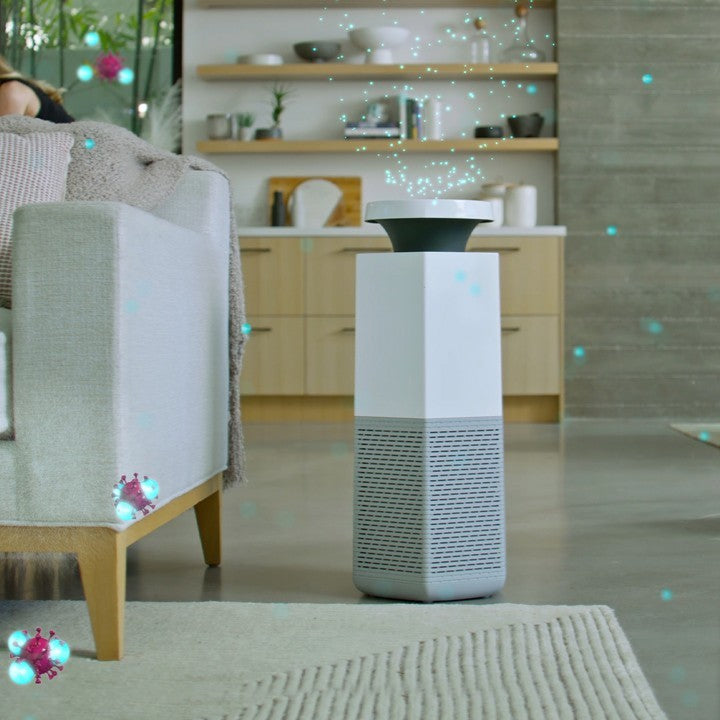 Puraclenz Core air purifier emitting ions into a room, actively targeting and deactivating mold spores in the air and on surfaces, with visual effect showing ions in motion