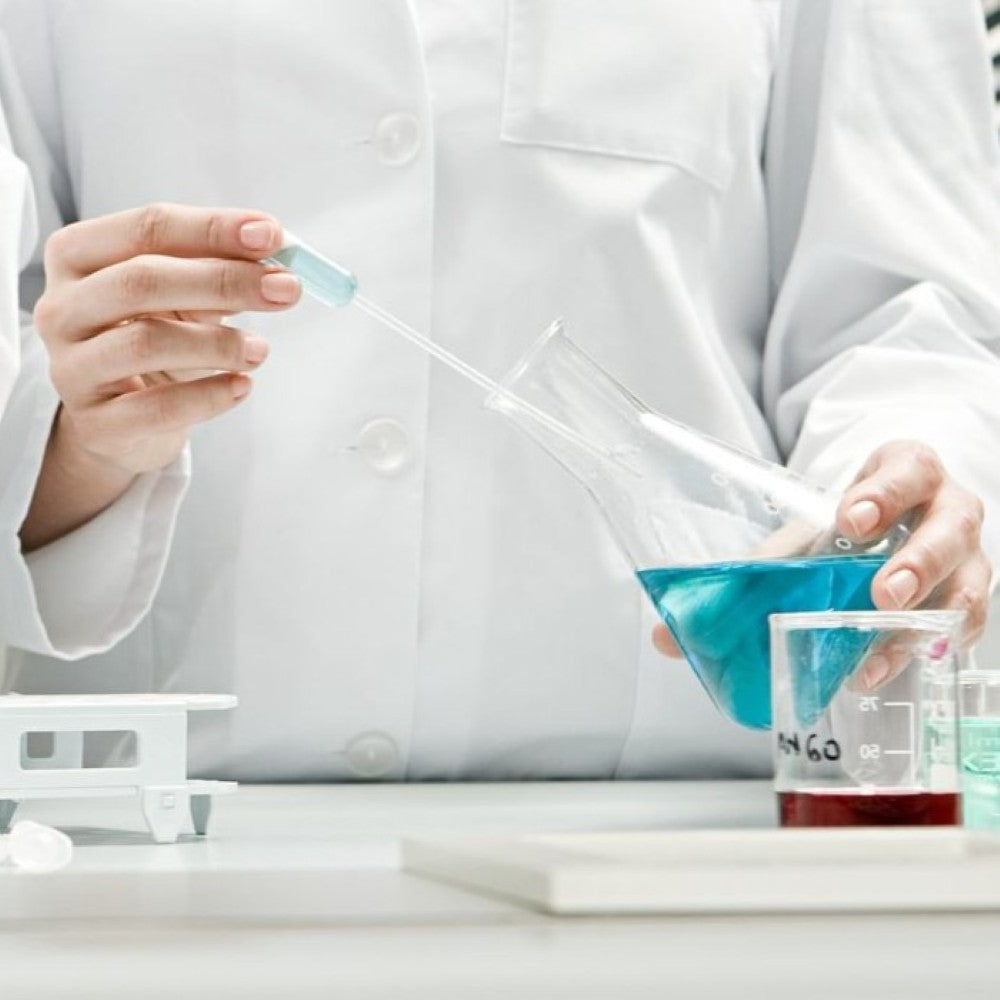 Laboratory technician handling glassware during independent testing to validate Puraclenz purification performance